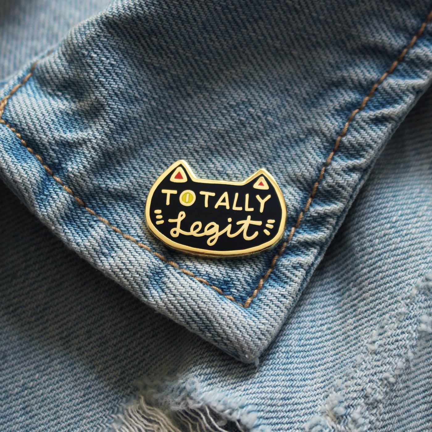 The pin worn on the pocket of a light denim jacket